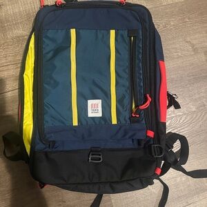 Topo Designs Men's Backpack in Blue, Yellow, and Red global travel bag 30 L